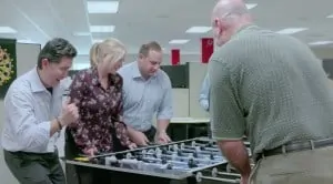 large image of people playing foosball at work